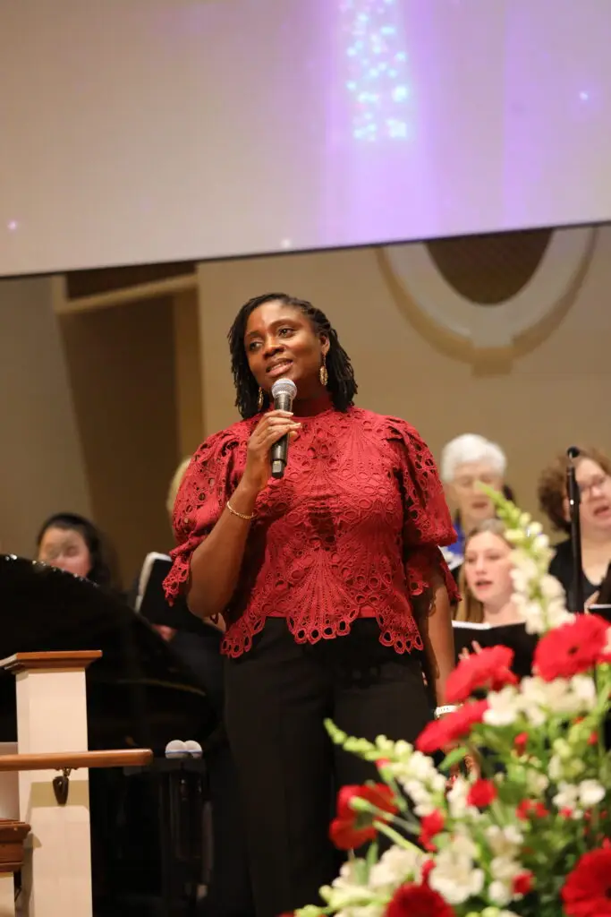 Singer leading a Christmas song in the Sanctuary
