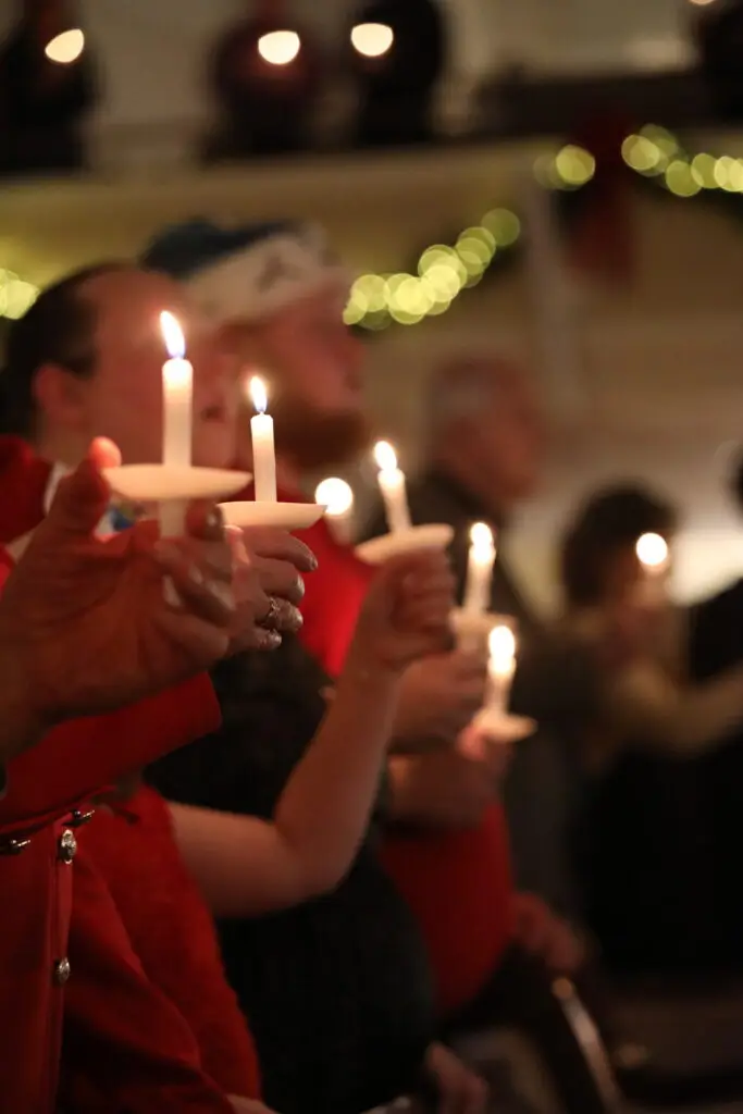 Guests holding candles during a Christmas Eve service at FBCPS